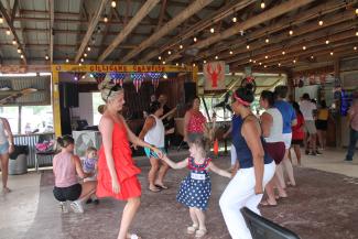 girls dancing to an upbeat band outside